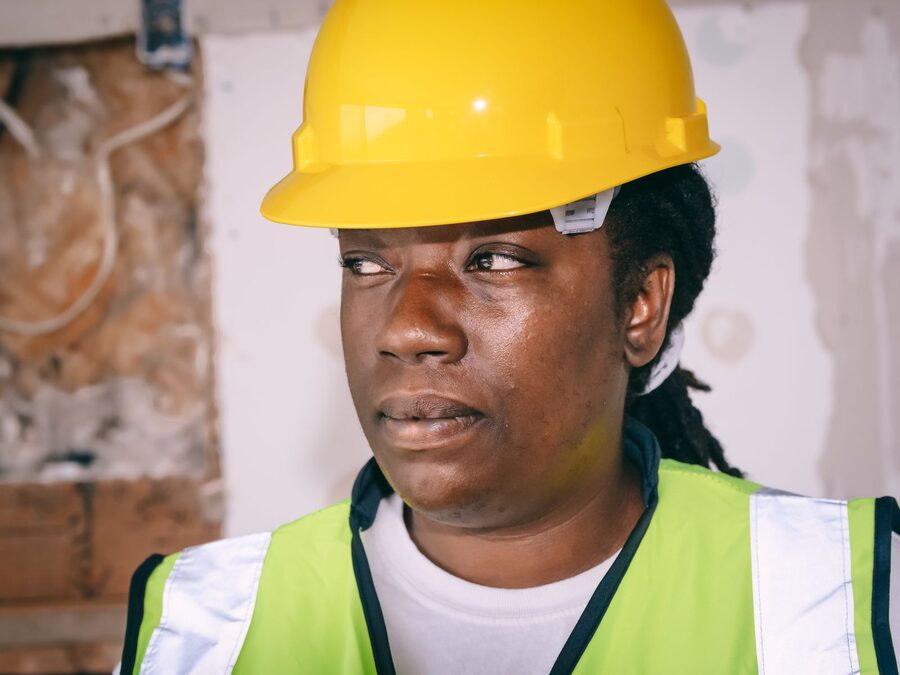 Industrial worker in hard hat and high-visibility clothing on a plant floor