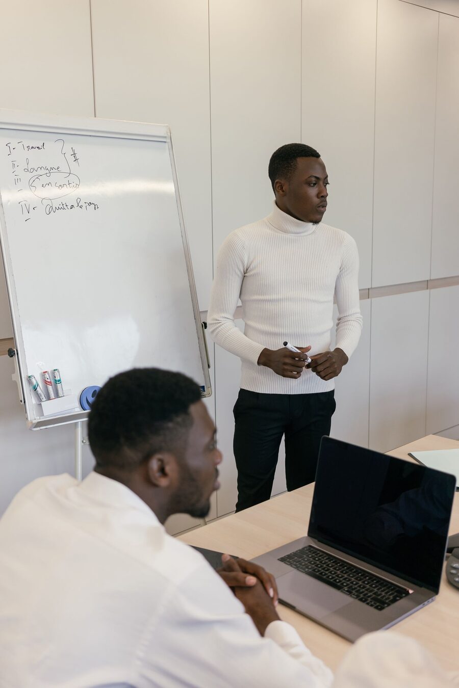 Two colleagues reviewing documents together in an office